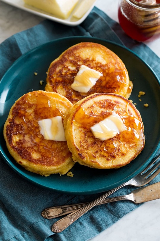 _*Johnny Cakes - Hoecakes*_ /These are a delicious, classic breakfast entree or dinner side that can be served savory with butter alone or sweet topped with honey, jam or maple syrup./   #Butter #Buttermilk #Cornmeal #Eggs #Flour #Milk #Sugar  Servings: 7 (2 per serving) Ready in: 25 minutes Prep: 15 minutes Cook: 10 minutes  Ingredients:  1 cup (5 oz) all-purpose flour (scoop and level to measure) 1 cup (5.6 oz) fine cornmeal 1 Tbsp granulated sugar 1 Tbsp baking powder (preferably aluminum free) 1/2 tsp salt 3/4 cup buttermilk 2/3 cup whole milk 2 large eggs 1/4 cup rendered bacon drippings or butter, melted 3 1/2 Tbsp vegetable oil for skillet, divided  Instructions: *1.* Heat a 12-inch cast iron skillet or a cast iron griddle over medium-low heat.  *2.* In a large mixing bowl whisk together flour, cornmeal, sugar, baking powder and salt until well blended. Make a well in center of mixture.  *3.* In a separate medium mixing bowl whisk together buttermilk, milk, eggs and bacon drippings until well blended (drippings will clump and that's ok).  *4.* Pour buttermilk mixture into dry mixture then whisk just until combined (it should be lightly lumpy). Let batter rest 1 minute.  *5.* Add 1 Tbsp vegetable oil to skillet. Pour a 1/4 cup slightly heaping batter into skillet at a time to create about three to four (3 1/2-inch) rounds (if it's thick you can spread it out slightly to that dimension).  *6.* Let cook until golden brown on bottom then carefully turn to opposite side, and cook until opposite side is golden brown and they are cooked through. (If they are browning too quickly before inside is done turn burner temp down slightly if they aren't cooking fast enough increase slightly. ) *7.* Transfer to a wire rack and repeat with remaining batter and oil (last batch should only have 2 so you'll only need 1/2 Tbsp oil for those).  *8.* Serve warm with butter, honey, jam or maple syrup if desired.  https://www.cookingclassy.com/johnny-cakes-hoecakes/