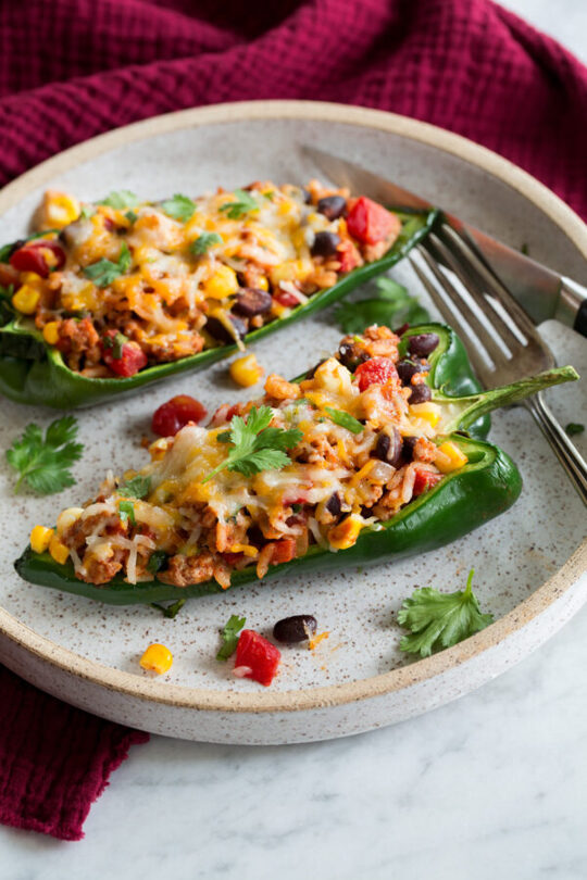 _*Stuffed Poblano Peppers*_ /Loaded with lean ground turkey, hearty rice and black beans, nutritious tomatoes and corn, and they're finished with melty cheese. It's a Tex-Mex dish that's brimming with flavor!/   #BlackBeans #CheddarCheese #ChiliPowder #Cilantro #Corn #Cumin #Garlic #GroundTurkey #Onions #Rice #Tomatoes  Servings: 6 (2 halves per person) Ready in: 45 minutes Prep: 20 minutes Cook: 25 minutes  Ingredients:  6 large (about 1 3/4 lbs) poblano peppers, halved lengthwise, seeds and ribs removed 1 Tbsp olive oil 1 cup chopped yellow onion (1 small) 1 Tbsp minced garlic (3 cloves) 1 lb. lean ground turkey 1 cup corn, fresh or frozen 1 (10 oz) can diced tomatoes with mild green chilies, well drained in a sieve 1/2 cup tomato sauce 1 cup (slightly packed) cooked white rice 1 (15 oz) can black beans, rinsed and drained 1 Tbsp chili powder 1 tsp ground cumin 1 1/2 cups shredded Mexican cheese blend, divided 1/4 cup chopped cilantro Salt and black pepper  Instructions: *1.* Preheat oven to 350 degrees. Place pepper halves on a 13 by 9-inch baking sheet in a single layer. Bake until tender crisp, about 10 - 15 minutes.  *2.* Meanwhile make the filling. Heat olive oil in a 12-inch non-stick skillet over medium-high heat. Add onion and saute 3 minutes. Add garlic and saute 30 seconds.  *3.* Scoot mixture to one far side. Add ground turkey and break into chunks, season with salt and pepper. Let cook while tossing and crumbling, until nearly cooked through. Add corn then finish cooking turkey through.  *4.* Remove from heat. Stir in diced tomatoes, tomato sauce, rice, black beans, chili powder, cumin and season with salt and pepper to taste.  *5.* Stir in 1/2 cup of the Mexican cheese blend and the cilantro.  *6.* Spoon filling into peppers filling them heaping full (you can press down slightly to fit more in). Sprinkle remaining 1 cup cheese blend over tops.  *7.* Return to oven and bake until cheese is nicely melted and peppers are softened to liking, about 8 to 10 minutes longer.  https://www.cookingclassy.com/stuffed-poblano-peppers/