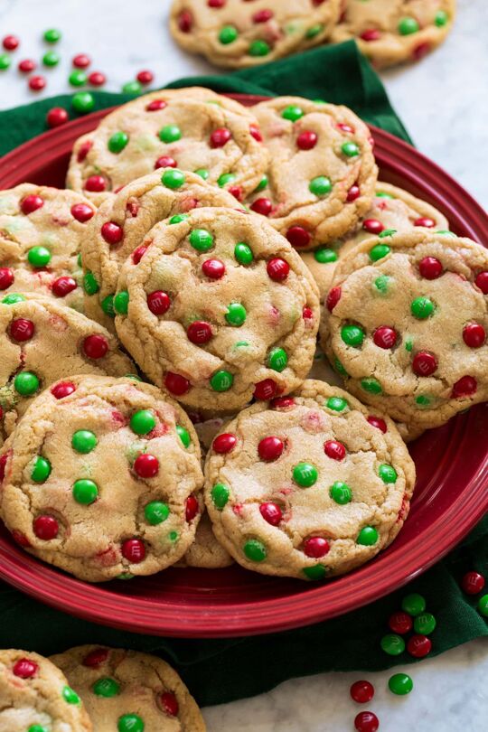 _*M&M Cookies Recipe*_ /A soft, chewy, buttery cookie that's much like a chocolate chip cookie but replaced with crisp shelled, sweet, multi-colored M&M's instead of chocolate chips. They are an absolute treat and so fun for people of all ages!/ #BrownSugar #Butter #Chocolate #EggYolk #Eggs #Flour #GranulatedSugar #Sugar #VanillaExtract Servings: 20 Ready in: 3 hours Prep: 30 minutes Cook: 13 minutes Ingredients: 2 1/3 cups (330g) all-purpose flour* (scoop and level flour to measure) 3/4 tsp baking soda 3/4 tsp salt 1 cup (226g) unsalted butter, at room temperature 1 cup (200g) packed light brown sugar 1/2 cup (100g) granulated sugar 1 large egg 1 egg yolk 2 tsp vanilla extract 1 1/2 cups (10 to 11.5 oz bag) M&M's regular or mini size, milk chocolate or dark chocolate Instructions: *1.* In a mixing bowl whisk together flour, baking soda, and salt. Set aside. *2.* In the bowl of an electric stand mixer fitted with the paddle attachment cream together butter, brown sugar and granulated sugar on low speed until well blended. Scrape down bowl. *3.* Mix in egg, then mix in egg yolk and vanilla extract. Scrape down bowl. *4.* Add flour mixture to butter mixture and mix just until combined. Then add half of the M&M's (3/4 cup) and mix in. *5.* Scoop dough out 3 Tbsp at a time and shape into balls (I recommend a #20 cookie scoop). Press remaining M&M's (3/4 cup) randomly around each dough ball. *6.* Transfer to a small baking sheet lined with parchment paper (or a large flat plate), cover and refrigerate 2 hours. *7.* During the last 15 minutes of chilling preheat oven to 350 degrees. Line two 18 by 13-inch baking sheets with parchment paper. *8.* Transfer 10 dough balls to lined baking sheet, spacing 2-inches apart. Bake in preheated oven until done to desired liking, about 13 to 16 minutes (they should appear slightly puffed and under-baked). *9.* Let cool on baking sheet 5 minutes then transfer to a wire rack to cool. Repeat with remaining cookie dough balls. Notes: *If you are at high altitude or if your cookies are normally prone to spreading use 2 1/2 cups (354g) all-purpose flour.
