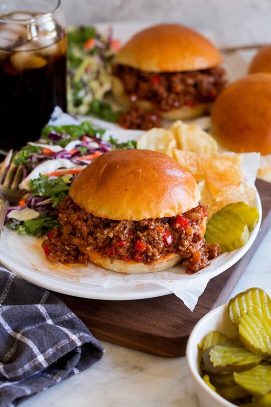 _*Sloppy Joes*_ /Homemade Sloppy Joes! Brimming with hearty browned beef, hidden veggies and a rich, lightly sweet, lightly smokey tomato based sauce. This recipe is fast, flavorful and sure to satisfy those old time cravings!/ #SloppyJoes #BeefAndPork #MainDish #Sandwiches #Beef #BellPepper #ChiliPowder #TomatoSauce Prep: 15 minutes. Cook: 15 minutes. Ready in: 30 minutes. INGREDIENTS: 1: 1 Tbsp olive oil. 2: 3/4 cup chopped yellow onion. 3: 3/4 cup chopped red bell pepper. 4: 1 lb lean ground beef*. 5: 2 garlic cloves, minced (2 tsp). 6: 1 tsp chili powder (regular or Ancho). 7: 1 tsp paprika (sweet or smoked). 8: 1/2 tsp ground mustard. 9: Salt and freshly ground black pepper. 10: 1 (8 oz) can tomato sauce. 11: 1/2 cup ketchup**. 12: 1 Tbsp Worcestershire sauce. 13: 1 tsp natural hickory smoke flavor. 14: Water or broth, for thinning as needed. 15: 4 hamburger buns, homemade or bakery fresh. INSTRUCTIONS: 1: Heat olive oil in a 12-inch non-stick skillet over medium-high heat. Add onion and bell pepper, saute until nearly tender, about 6 minutes. Scoot to one far side of the pan. 2: Crumble in beef, let sear until browned on bottom, about 2 - 3 minutes. Then turn and start to break up beef and toss with peppers and onions, continue to cook 2 - 3 minutes or until nearly cooked through. 3: Drain fat from beef. Add garlic, chili powder, paprika, mustard and season with salt and pepper to taste and cook beef through, about 1 minute, tossing occasionally. 4: Stir in tomato sauce, ketchup, Worcestershire, smoke flavor. Reduce heat and simmer until heated through, about 2 minutes. Thin the mixture with splashes of water, beef broth or chicken broth as needed. 5: Serve warm in hamburger buns. Notes: *Ground turkey can be substituted (don't use super lean). **I like to use a corn syrup-free ketchup such as Simply Heinz or Trader Joes. Pair with grilled corn, coleslaw, potato chips, pickle spears or potato salad.