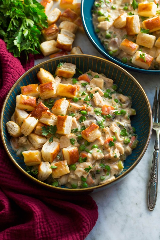 _*Chicken Pot Pie with Puff Pastry Bites*_ /Chicken Pot Pie with Puff Pastry (Bites!) – It’s easily one of the best ways to make pot pie! You get a creamy, richly flavored chicken and vegetable base thats topped with bite size pieces of golden brown, super flakey, buttery puff pastry. It’s the ultimate cozy comfort food./ #Butter #Carrots #Celery #Chicken #ChickenBroth #Eggs #Flour #Garlic #Milk #Mushrooms #ParmesanCheese #Parsley #Peas #PuffPastry #Thyme #YellowOnions Servings: 6 Ready in: 50 minutes Prep: 25 minutes Cook: 25 minutes Ingredients: 1 pkg (17 to 18 oz) frozen puff pastry, thawed according to package directions 1 large egg 1 Tbsp water 1 Tbsp olive oil 1 1/2 cups (chopped) yellow onion 1 1/4 cups thin chopped celery 1 1/4 cups peeled and chopped carrots 6 oz. mushrooms, sliced 5 Tbsp butter, cut into pieces 1 Tbsp minced garlic 1/2 cup all-purpose flour, plus more for dusting puff pastry 1 (15 oz) can low-sodium chicken broth, then more to thin as desired 1 3/4 cups whole milk 2 tsp minced fresh thyme Salt and black pepper, to taste 3 1/2 cups cooked shredded chicken (preferably rotisserie or bone-in cooked chicken) 1 1/2 cups frozen petite peas 1/3 cup grated (1.5 oz) parmesan cheese 3 Tbsp chopped fresh parsley, plus more for garnish Instructions: *1.* Preheat oven to 400 degrees. Unfold puff pastry onto a lightly floured surface, sprinkle top with a little flour then spread evenly over top. *2.* Cut puff pastry into 1-inch squares. Transfer to a 18 by 13-inch baking sheet lined with parchment paper. *3.* In a mixing bowl whisk together egg with the 1 Tbsp water until well blended. Light brush some of the egg mixture over top of puff pastry then spread pieces out even. *4.* Bake in preheated oven until nicely puffed and richly golden brown, about 11 to 15 minutes. *5.* While puff pastry is baking prepare filling. In a 12-inch skillet heat olive oil over medium-high heat. *6.* Add onions, celery, carrots, mushrooms and saute tossing only occasionally (about every 2 to 3 minutes so mushrooms and veggies brown a little), cooking until veggies soften, about 10 to 12 minutes. *7.* Add butter and garlic and saute 1 minutes. Sprinkle in flour, then cook tossing constantly 1 minute. *8.* Reduce heat to medium, while whisking slowly pour in chicken broth then milk. Add thyme and season with salt and pepper to taste. Let cook until thickened, while stirring. *9.* Reduce heat low stir in chicken. Let heat for a few minutes, stirring occasionally. Stir in peas, parmesan and parsley and warm through. *10.* Thin mixture with more chicken broth as desired (or milk). Serve warm in bowls and top with puff pastry pieces garnished with a little more parsley. Notes: Recipe makes about 9 cups filling. https://www.cookingclassy.com/chicken-pot-pie-puff-pastry/