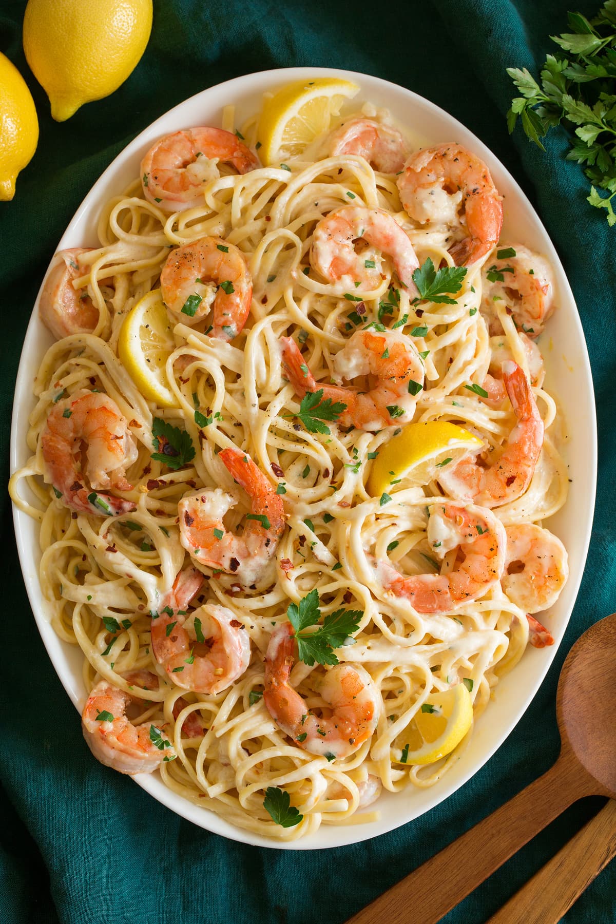 _*Creamy Lemon Shrimp Pasta*_ /It's delicious classic comfort food fit for any day of the week! It's made with tender linguine pasta, savory shrimp, and both are tossed in a rich, vibrantly lemony, cream-based parmesan cheese sauce./   #Butter #Cream #Garlic #Lemons #ParmesanCheese #Parsley #Pasta #Shrimp  Servings: 5 Ready in: 40 minutes Prep: 20 minutes Cook: 20 minutes  Ingredients:  12 oz. dry linguine Salt and freshly ground black pepper 1 Tbsp olive oil 1 lb. large shrimp* (or extra large) 1 Tbsp minced garlic (3 cloves) 1 cup heavy cream 2 tsp lemon zest 1/4 tsp red pepper flakes (or to taste) 4 Tbsp butter, cut into 1-Tbsp pieces 1 cup finely shredded parmesan cheese (2.5 oz) 2 1/2 Tbsp fresh lemon juice 1 Tbsp parlsey, for garnish (optional)  Instructions: *1.* Bring a large pot of water to a boil (with about 4 quarts water). Season water with salt and cook pasta to al dente according to directions listed on package. Before draining reserve 1 cup pasta water.  *2.* Meanwhile heat olive oil in a large non-stick skillet over medium-high heat.  *3.* Dab shrimp dry with paper towels, season with salt and pepper. Add to skillet in a single layer.  *4.* Let cook until pink on bottom, about 1 - 2 minutes. Add garlic, turn shrimp and continue to cook until cooked through (shrimp should be opaque).  *5.* Transfer shrimp to a sheet of foil and wrap loosely to keep warm.  *6.* In a medium saucepan heat cream along with lemon zest and red pepper flakes over medium heat. Bring to a simmer, then reduce heat to low and let simmer until reduced slightly, about 2 minutes.  *7.* Add in butter and whisk until melted.  *8.* Remove cream mixture from heat, then stir in parmesan cheese. Stir until cheese has melted. Season sauce with salt and pepper to taste.  *9.* In the skillet used to cook shrimp toss the drained linguine with sauce and lemon juice. Thin with pasta water as needed. Toss in shrimp.  *10.* Serve warm garnished with parsley if desired.   Notes: Shrimp usually loses some water weight, so while the package may say 1 1/4 lbs it's usually more like 1 lb. Same with frozen shrimp once thawed.  https://cookingclassy.com/lemon-shrimp-pasta/