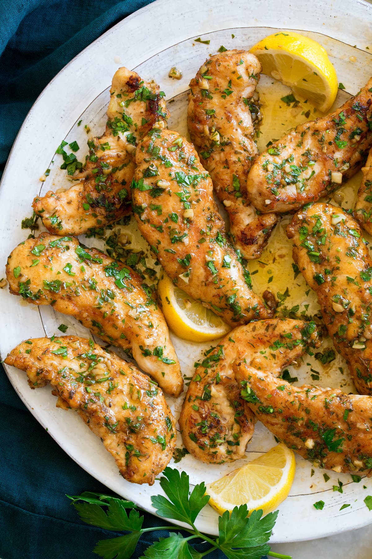 _*Lemon Butter Chicken Tenders*_ /Lemon Butter Chicken Tenders - small strips of chicken are tossed with herbs and spices and seared until golden brown, then finished with a simple garlicky, lemon-butter pan sauce. It's a no fuss, super fast and easy to make chicken recipe that doesn't disappoint!/   #Butter #Chicken #Flour #Garlic #Lemon #OliveOil #Oregano #Paprika #Parsley #Thyme  Servings: 4 Ready in: 15 minutes Prep: 10 minutes Cook: 6 minutes  Ingredients:  1 1/2 lbs chicken tenders (or tenderloins) Salt and freshly ground black pepper 1/2 tsp dried oregano 1/2 tsp dried thyme 1/2 tsp paprika 1 1/2 Tbsp all-purpose flour 1 Tbsp olive oil 3 Tbsp unsalted butter, divided 1 Tbsp minced garlic 2 Tbsp fresh lemon juice 3 Tbsp minced parsley  Instructions: *1.* Heat a 12-inch skillet over medium-high heat.  *2.* Season chicken tenders with salt and pepper. Then evenly sprinkle over oregano, thyme, paprika, and flour. Toss to evenly coat.  *3.* Add oil to the skillet along with 1 Tbsp butter. Carefully tilt pan to evenly coat.  *4.* Add chicken tenders to skillet, leaving a little space between them.  *5.* Let cook until golden brown on bottom, about 3 minutes. Turn and cook 2 minutes or until nearly cooked through.  *6.* Once chicken is nearly cooked through (about 155 in center) add remaining 2 Tbsp butter and sprinkle garlic around the chicken (don't sprinkle on the chicken or it won't cook).  *7.* Continue to cook until chicken is just cooked through (165 in center of each piece), about 1 minute longer.  *8.* Remove from heat. Carefully pour in lemon juice and add parsley. Toss to coat then serve.  https://www.cookingclassy.com/lemon-butter-chicken-tenders/