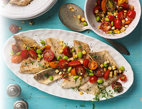 _Grilled Perch with Charred Corn and Tomato Salad_ /Keep the heat out of the kitchen and cook your meal outdoors. Perch fillets cook quickly and are delightful with this colourful grilled salad./ *Grilling Time:* 26 minutes *Preparation Time:* 10 minutes *Serves:* 4 _Ingredients_ 2 cobs Corn, husked 1 Red Onion, cut into 1/2-inch (1 cm) thick slices 3 tbsp (45 mL) vegetable oil (approx.) 1-1/2 cup (375 mL) Grape *or* Cherry Tomatoes, halved 1/2 cup (125 mL) cooked shelled Edamame 2 tbsp (25 mL) red wine vinegar 2 tsp (10 mL) chopped fresh Thyme Leaves Salt and pepper 1 clove Garlic, minced 1 lb (500 g) fresh Perch Fillets (skin on), 12 to 16 fillets 1 tbsp (15 mL) melted butter _Instructions_ Brush corn and onion slices with some of the oil. Grill, covered, over medium-high heat, turning often until lightly charred and tender-crisp, 10 to 15 minutes. Remove vegetables as they are cooked. Toss tomatoes with 1/2 tsp (2 mL) of the oil. Place in grill basket; grill, covered, over medium heat, stirring occasionally, until lightly softened, about 5 minutes. When cool enough to handle, cut kernels from cobs and place in medium bowl. Chop onion and add to corn along with tomatoes and edamame. Whisk together 2 tbsp (25 mL) of the oil, vinegar, thyme, 1/4 tsp (1 mL) salt, pinch of pepper and garlic. Add to vegetables, toss gently and set aside. Lightly brush fish fillets with remaining oil; season to taste with salt and pepper. Place skin side down on large flat barbecue topper. Grill over medium-high heat until fish flakes easily with fork, 2 to 3 minutes per side. Place fillets on large platter and drizzle with butter; serve with salad. _Nutritional information_ *PROTEIN:* 27 grams *FAT:* 16 grams *CARBOHYDRATE:* 16 grams *CALORIES:* 312 *FIBRE:* 3 grams *SODIUM:* 275 mg