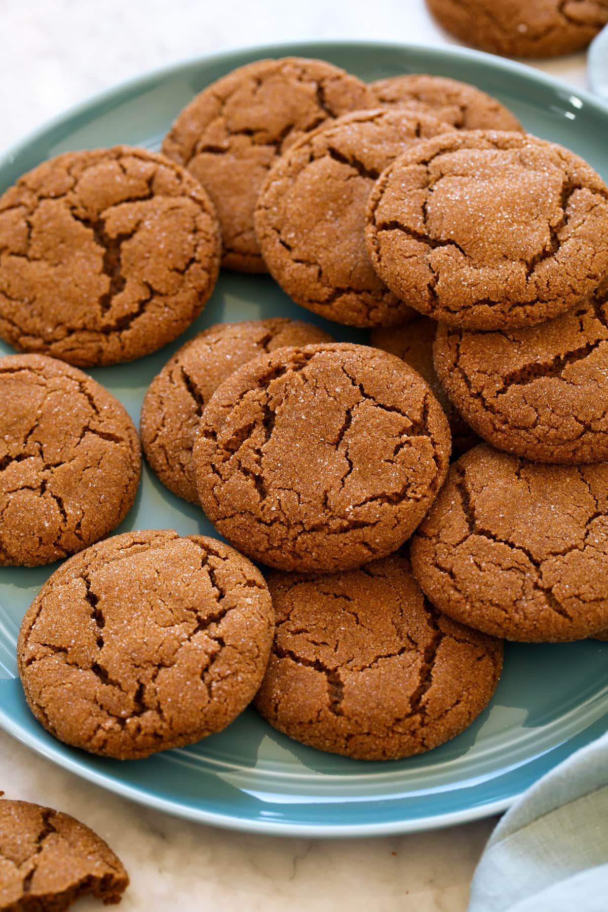_*Molasses Cookies*_ /An incredibly soft and chewy cookie, brimming with rich, deep molasses flavor and boasting of warm spices to perfectly highlight them. They're deliciously sweet and buttery and oh so addictive! A holiday staple!/   #BrownSugar #Butter #Cinnamon #Cloves #EggYolks #Flour #Ginger #GranulatedSugar #Molasses #Nutmeg #VanillaExtract  Servings: 24 Ready in: 40 minutes Prep: 20 minutes Cook: 20 minutes  Ingredients:  2 cups (283g) unbleached all-purpose flour (scoop and level to measure) 1 tsp baking soda 1/2 tsp salt 2 tsp ground ginger 1 1/2 tsp ground cinnamon 1/4 tsp ground cloves 1/4 tsp ground nutmeg 3/4 cup (170g) unsalted butter, at room temperature 3/4 cup (150g) packed light brown sugar 1/4 cup + 2 Tbsp molasses* 1 large egg yolk 2 tsp vanilla extract 1/4 cup (50g) granulated sugar  Instructions: *1.* Preheat oven to 350 degrees. Line two 18 by 13-inch baking sheets with parchment paper, set aside. *2.* In a medium mixing bowl whisk together flour, baking soda, salt, ginger, cinnamon, cloves and nutmeg for 30 seconds, set aside. *3.* In the bowl of an electric stand mixer fitted with the paddle attachment, blend together butter and brown sugar until well combined. Scrape down sides and bottom of bowl. *4.* Mix in molasses, egg yolk and vanilla extract. Scrape down sides and bottom of bowl. *5.* Add flour mixture and mix until combined. *6.* Pour granulated sugar into a small bowl. Scoop dough out and shape into balls nearly the size of a golf ball (30g each). *7.* Roll each dough ball through granulated sugar then transfer to baking sheets spacing 2-inches apart. *8.* Bake one sheet at a time in preheated oven 9 - 11 minutes until cookies are puffed and appear just lightly under-baked in the center. *9.* Let cool on baking sheet 5 minutes then transfer to a wire rack to cool completely. *10.* Store cookies in an airtight container at room temperature up to 4 days.  Notes: *To measure I spray a liquid measuring cup with non-stick cooking spray then pour in enough until it reaches right in between the 1/4 cup and the 1/2 cup mark.