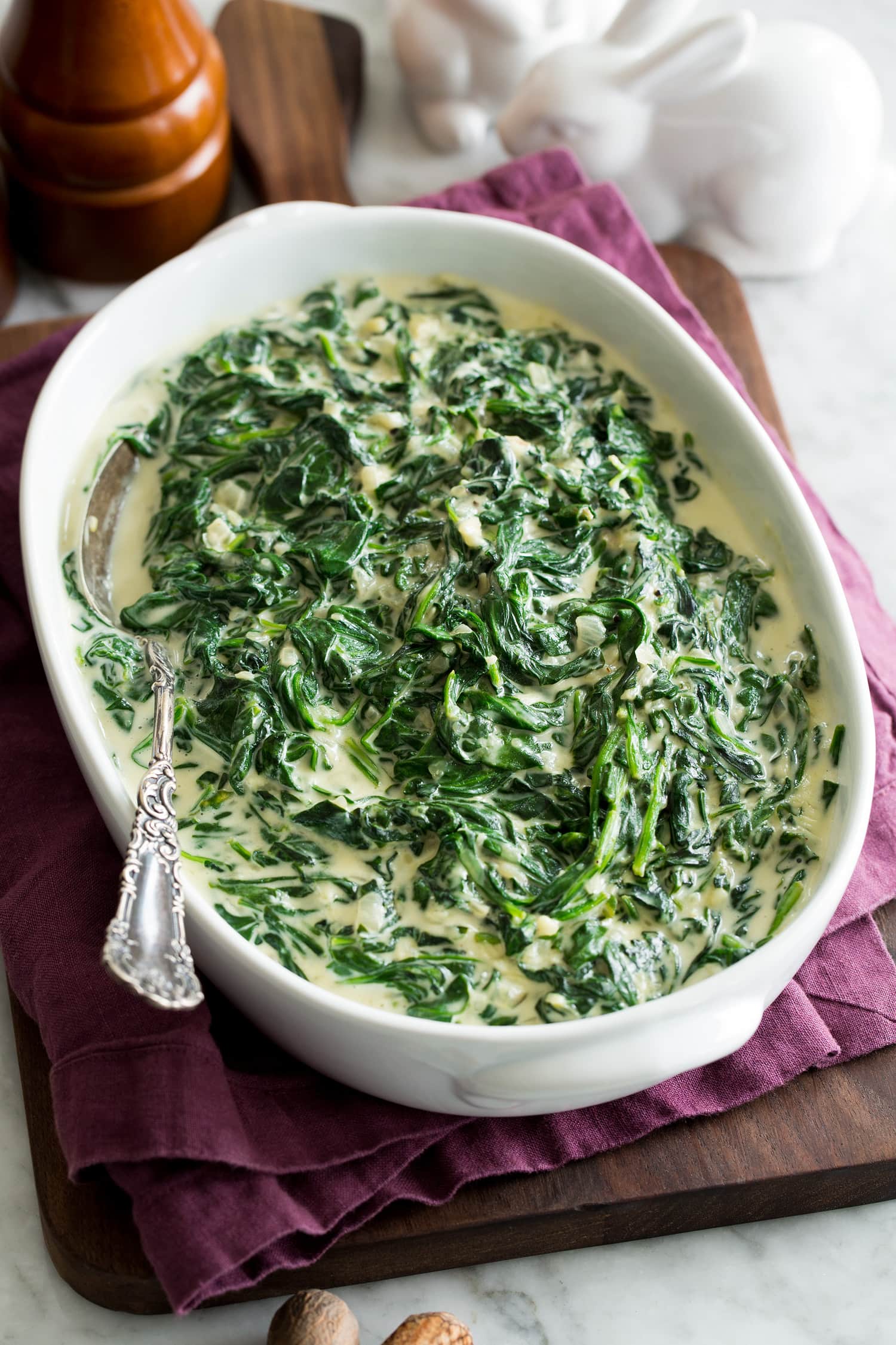 _*Creamed Spinach*_ /The ultimate Creamed Spinach recipe! It's made over-the-top delicious with fresh spinach, vibrant shallot and garlic, rich heavy cream, cream cheese and parmesan cheese. It's supremely creamy and perfectly flavorful!/   #Butter #Cream #CreamCheese #Flour #Garlic #Parmesan #Shallots #Spinach  Servings: 5 (about 5 cups) Ready in: 20 minutes Prep: 10 minutes Cook: 10 minutes  Ingredients:  3 Tbsp unsalted butter, cut into 1-Tbsp pieces 1/2 cup finely chopped shallot 1 Tbsp minced garlic 2 lbs baby spinach 2 1/2 Tbsp all-purpose flour 2/3 cup heavy cream 2 pinches nutmeg (preferably freshly grated) optional Salt and black pepper 4 oz. cream cheese, cut into small cubes and softened 3/4 cup (1.5 oz) finely shredded parmesan cheese  Instructions: *1.* Melt butter in large pot over medium heat. Add shallot and saute until softened and lightly deepening in color, about 2 to 3 minutes. Add garlic and saute 30 seconds longer.  *2.* Add spinach in four batches, tossing between each until spinach is nearly wilted each time.  *3.* Sprinkle in flour and cook and toss for 1 minute.  *4.* While stirring pour in heavy cream. Season with salt and pepper to taste and nutmeg. Cook and stir until mixture is thickened, about 1 minute.  *5.* Reduce heat to low then add cream cheese and parmesan cheese and stir until cheeses are melted. Transfer to a serving dish so spinach doesn't continue to cook and serve warm.