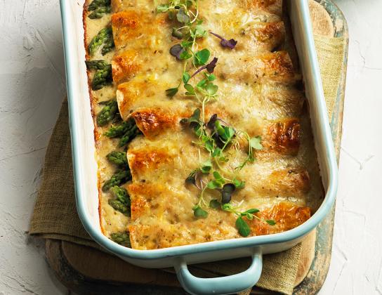 _*Asparagus and Chicken Enchiladas*_ /Fresh, crisp asparagus is the star in this family-friendly supper. A small amount of light sour cream adds creaminess without a lot of added calories. Serve with a green salad./   #CalendarRecipe #Dinner #MainDishes  Cooking Time: 15 minutes Baking Time: 25 minutes Preparation Time: 10 minutes  Ingredients:  1 lb (500 g) Ontario Asparagus, trimmed 2 tbsp (25 mL) butter 1 Ontario Onion, chopped 1/4 cup (50 mL) all-purpose flour 1-1/2 cups (375 mL) chicken broth 2 cups (500 mL) shredded Ontario Old Cheddar Cheese 1/2 cup (125 mL) salsa verde or tomatillo salsa (green salsa) 1/4 cup (50 mL) low fat Ontario Sour Cream Salt, pepper and crushed red pepper flakes 8 8-inch (20 cm) whole wheat flour tortillas 2 cups (500 mL) shredded cooked Ontario Chicken Ontario Pea Sprouts and salsa verde  Instructions: *1.* In large pot of boiling water, cook asparagus until tender-crisp, 3 to 4 minutes. Drain and rinse under cold water; set aside.  *2.* In medium saucepan, melt butter over medium heat. Add onion and cook until softened, 2 to 3 minutes. Stir in fl our until absorbed. Gradually stir in broth and bring to boil, stirring constantly. Reduce heat and simmer until thickened, 2 to 3 minutes. Remove from heat; stir in 1/2 cup (125 mL) of the cheese until melted. Stir in salsa and sour cream. Season to taste with salt, pepper and red pepper fl akes.  *3.* Sprinkle each tortilla with 2 tbsp (25 mL) of the cheese and 1/4 cup (50 mL) of the shredded chicken. Arrange asparagus spears in centre of each tortilla. Spoon 2 tbsp (25 mL) of the sauce over each, roll-up and place seam side down in greased 13- x 9-inch (3 L) baking dish. Pour remaining sauce over and sprinkle with remaining cheese.  *4.* Bake in 350°F (180°C) oven until sauce is bubbly and cheese is melted, about 25 minutes. Sprinkle with pea sprouts and additional salsa.