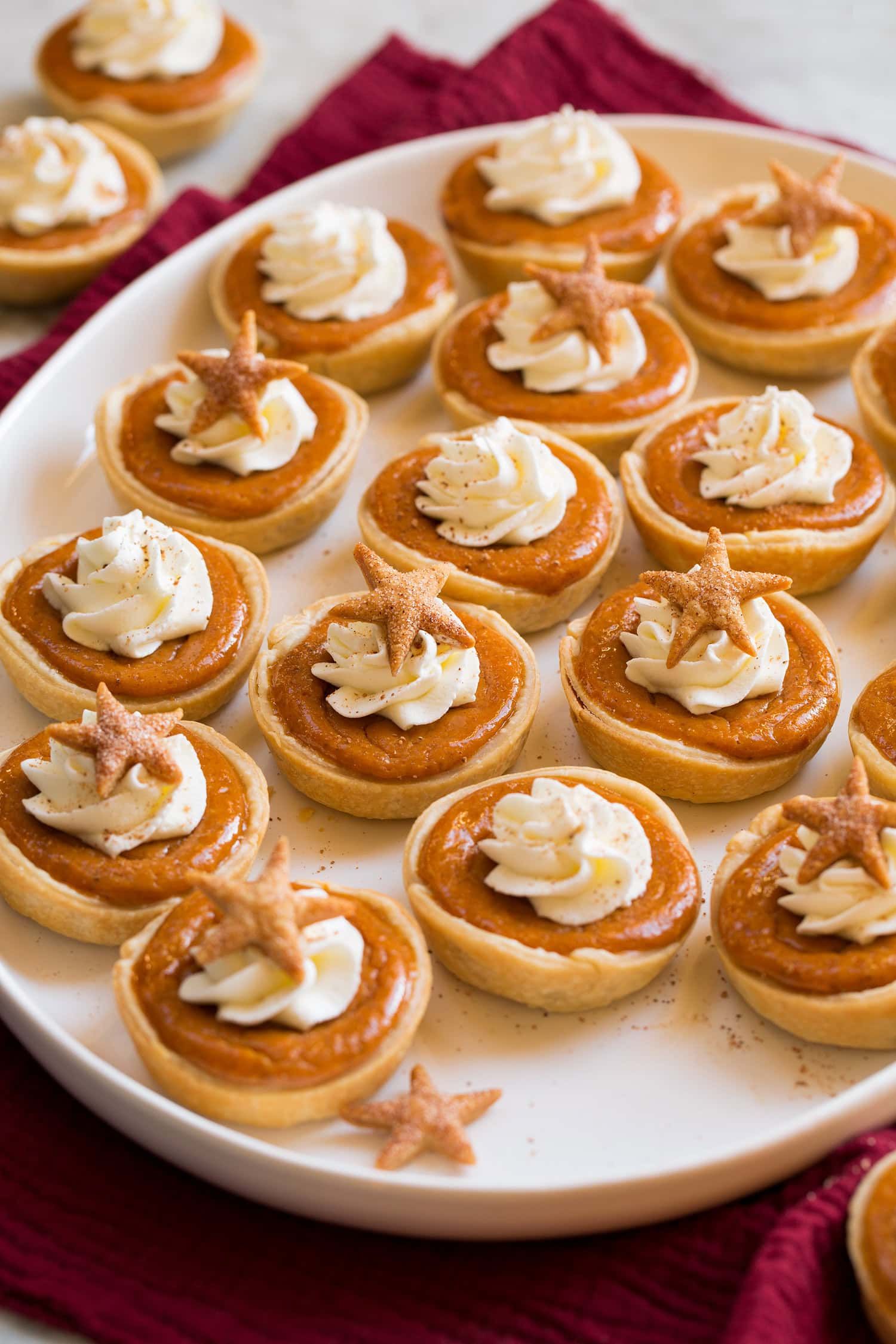 _*Mini Pumpkin Pies*_ /Fun and festive Mini Pumpkin Pies! Made simple with flaky store-bought pie crust, canned pumpkin puree, and rich sweetened condensed milk. And of course they also include an ideal amount of those traditional warm pumpkin pie spices we crave./   #MiniPumpkinPies #Desserts #FallFaves #PiesAndCheesecakes #Thanksgiving #CannedPumpkin #Cinnamon #Cloves #Eggs #Ginger #Nutmeg #PieCrust #SweetenedCondensedMilk  Prep: 20 minutes. Cook: 20 minutes. Ready in: 1: hour  hour.  INGREDIENTS: 1: 2 refrigerated prepared pie crusts (14 oz), store-bought. 2: 1 (15 oz) can pumpkin (not pie filling). 3: 1 (14 oz) can sweetened condensed milk. 4: 2 large eggs. 5: 1 1/4 tsp ground cinnamon*. 6: 1/2 tsp ground nutmeg. 7: 1/4 tsp ground ginger. 8: 1/8 tsp ground cloves. 9: 1/4 tsp salt. 10: Sweetened whipped cream, for serving (optional).  INSTRUCTIONS:  1: Adjust oven rack to lower 1/3 of the oven. Preheat oven to 375 degrees. Spray 20 wells of cupcake pans with non-stick cooking spray (dark cupcake pans work best if you have them for more golden brown crust). 2: In a mixing bowl whisk together pumpkin, sweetened condensed milk, eggs, cinnamon, nutmeg, ginger, cloves and salt until well combined. Rap bowl against counter to remove large air bubbles and set aside. 3: Roll each pie crust out slightly thinner to about a 12-inch round. Cut into 3 1/2-inch rounds using a round cookie cutter. Transfer rounds to prepared muffin pans and press pie crust into bottom and sides of muffin wells. 4: Gather scraps and re-roll thinly, cut more rounds from dough. You should be able to get 20. Optionally with leftover scraps from here you can cut mini leaf or star shapes, spray with cookie spray and sprinkle with cinnamon sugar then place those on the tops of the muffin pans between mini pies. 5: Bake in preheated oven until set through to the center, about 18 to 22 minutes. 6: Transfer to a wire rack and cool in pan 20 minutes. Use an offset spatula to slide pies out, then cool completely on wire rack. 7: Top with sweetened whipped cream and garnish with a pie crust decoration if using. Store pies in the fridge. Notes: *2 tsp pumpkin pie spice can be used in place of cinnamon, nutmeg, ginger and cloves. Nutrition estimate does not include sweetened whipped cream topping as it is optional.    