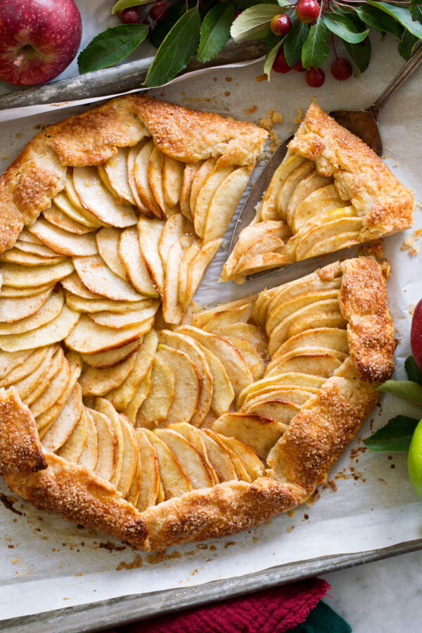 _*Apple Galette*_ /Apple Galette – A buttery pie-style crust is layered with plenty of sweetened fresh apples and then baked until the fruit is tender and the crust is beautifully golden brown and supremely flakey. It’s one of the absolute best fall desserts!/ #Apples #Butter #Cinnamon #Eggs #Flour #Honey #Sugar Servings: 8 Ready in: 2 hours Prep: 30 minutes Cook: 40 minutes Ingredients: Crust 1 1/2 cups (214 g) unbleached all-purpose flour (scoop and level to measure) 1 Tbsp (11 g) granulated sugar 1/4 tsp salt 10 Tbsp (142 g) unsalted butter, cut into 1/2-inch cubes 4 to 5 Tbsp ice water Filling 1 1/2 lbs (3 large) baking apples* 1/4 cup (50 g) granulated sugar** 1/2 tsp ground cinnamon 2 Tbsp (28 g) unsalted butter, diced into 1/4-inch cubes Finish 1 large egg + 1/2 Tbsp water 1 Tbsp (11 g) turbinado sugar or sparkling sugar 1 Tbsp honey or 1 1/2 Tbsp apricot preserves heated with 1/2 tbsp water and strained (optional) Instructions: *1.* In a large mixing bowl whisk together flour, sugar and salt. *2.* Add 10 Tbsp butter cubes and cut into mixture using a pastry blender until there are just small pea size clumps of butter throughout (some larger are fine). *3.* Drizzle in 1 Tbsp ice water at a time and toss right away, adding just enough water until mixture comes together in larger clumps. Dump dough out onto a clean surface and knead several times until dough just comes together. *4.* Press into an even disk (about 5 to 6 inches across). Wrap in plastic wrap and chill 30 to 60 minutes. *5.* Preheat oven to 375 degrees. Line a rimmed 18 by 13-inch baking sheet with parchment paper. *6.* Remove dough from fridge, dust top with flour and roll out onto a well floured surface to about a 13. 5-inch round. *7.* Fold dough in half then in half again and transfer to a parchment paper lined baking sheet with the corner in the center and unfold the dough (it will run up the sides of the pan and that's ok). Transfer to fridge. *8.* Peel, core, halve and thinly slice each of the apples (about 1/6th-inch thickness, if using golden delicious slice 1/4-inch). *9.* Place apples in a large mixing bowl, add 1/4 cup sugar and the cinnamon and toss to evenly coat. *10.* Align apples in a circular pattern over crust, leaving about a 2-inch edge uncovered with apples. *11.* Fold dough edges up over apples. Start at one point in the round then move around the crust folding up about every 3-inches. *12.* In a mixing bowl whisk egg with water then use a pastry brush to brush edges of the pie crust. Sprinkle edges with the turbinado sugar. Dot remaining 2 Tbsp butter over apples. *13.* Bake in preheated oven until apples are tender, about 40 to 50 minutes. After removing from the oven *14.* Let cool for about 10 minutes. Brush with honey or apricot preserves if desired before slicing. Serve with vanilla ice cream if desired. Notes: *I like to use a blend of three types different baking apples. Good options are honeycrisp, pink lady, granny smith, empire, braeburn, jonagold, cortland and golden delicious (don't slice golden delicious apples as thin, only 1/4 to 1/3-inch). **If using tart apples and you'd like a sweeter dessert you may want to consider adding an additional 2 Tbsp sugar. https://www.cookingclassy.com/apple-galette/