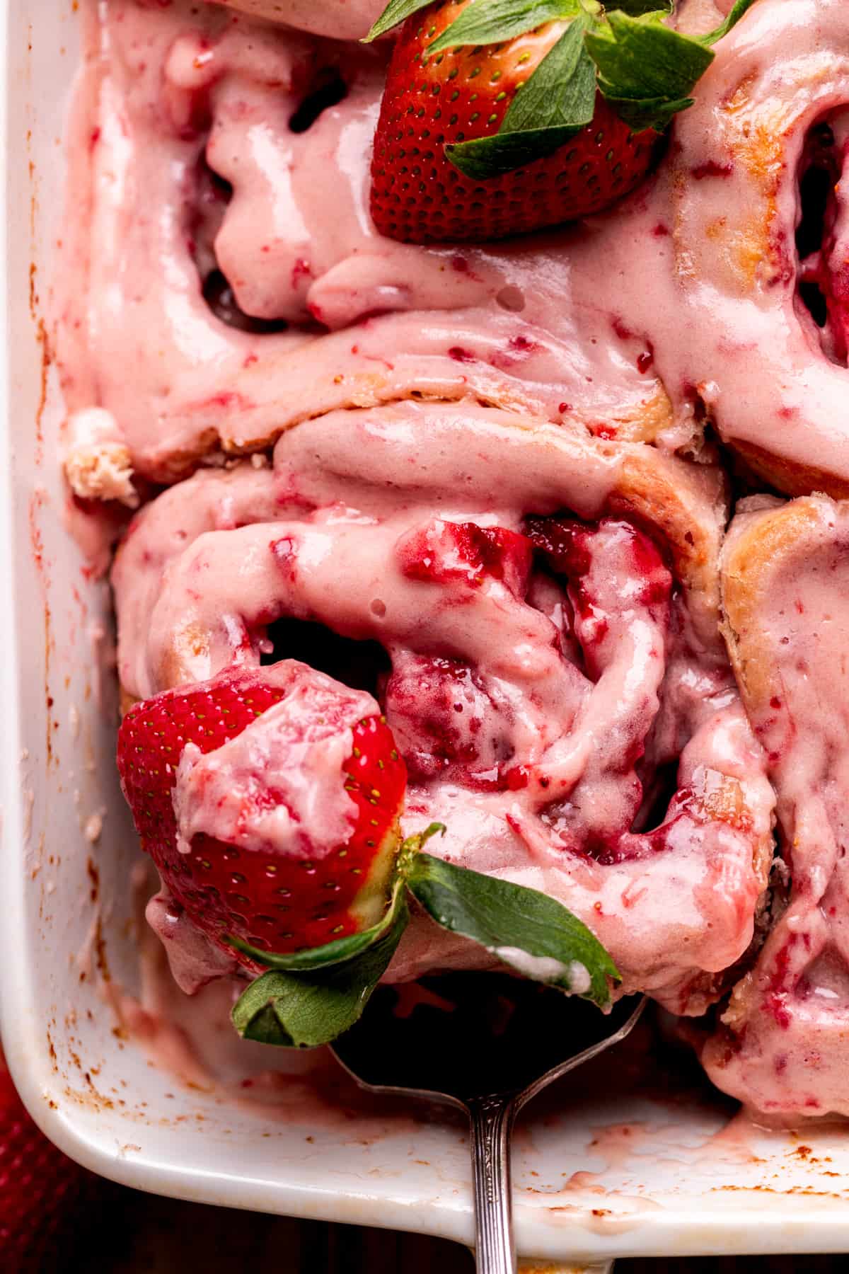 _*Sweet Strawberry Rolls*_  These sweet strawberry rolls are super gooey rolls that taste like strawberries and creamy. It is filled with a strawberry filling and strawberry preserves. The rolls are topped with cream cheese glaze. These are perfect to make for brunch!  *Ingredients* /Dough/  1 cup Milk warmed to 110F  2 Packets of dry active yeast equal to 14 grams  2 Large eggs room temperature slightly beaten  4 1/2 cups All-purpose flour  1 tsp Salt  1/4 cup White granulated sugar  10 TBSP Unsalted butter room temperature and cubed  /Strawberry Filling/  1/2 cup Unsalted butter room temperature  1/2 cup White granulated sugar  1/4 cup Brown sugar packed light brown sugar  2 TBSP Grounded Freeze dried strawberries Ground the strawberries then measure  /Strawberry Preserves/  2 cups Diced strawberries washed and diced into small pieces.  1/3 cup White granulated sugar  1 1/2 TBSP Cornstarch  3 TBSP Water  1 TBSP Lemon juice  /Cream Cheese Glaze/  4 oz Cream cheese room temperature  4 TBSP Unsalted butter room temperarature  2 tsp Pure vanilla extract  1 1/2 cups Powdered sugar sifted  3 TBSP Milk or Heavy cream  *Instructions* /Dough/   1. Heat the milk in the microwave for 1 minute. Make sure it is around 110°F. Pour both packets of yeast into the milk. Let it sit for 10 minute for it foam and activate.  1 cup Milk, 2 Packets of dry active yeast   2. These instructions are for a stand mixer with a dough hook. For making this by hand, see the recipe notes. In a large mixing bowl, sift the flour. Add in salt and sugar.  4 1/2 cups All-purpose flour, 1 tsp Salt, 1/4 cup White granulated sugar   3. Pour all the cubed butter into the dry ingredients. Use a pastry cutter or a fork to cut the butter into the dry ingredients. The butter needs to be the size of a pea.  10 TBSP Unsalted butter   4. Pour milk/yeast and beat eggs on top of dry ingredients. Use the dough hook and low speed and mix until a dough starts to form. Switch to medium speed and knead for 5 minutes. The dough should be tacky.  2 Large eggs   5. Preheat the oven to 200°F. Spray a large mixing bowl with nonstick cooking spray. Place the dough in the bowl and cover with a towel. Place in the oven and turn off the oven and crack open the door. Let it sit for 1 hour. Let it double in size.  /Strawberry Preserves/  1. Make this asap, so it can cool before using.  2. Using a medium saucepan, add diced strawberries, sugar, cornstarch, water, and lemon juice. Heat until the strawberries start to release their juice, don't mash the berries. Heat until it is bubbling and thickens.  2 cups Diced strawberries, 1/3 cup White granulated sugar, 1 1/2 TBSP Cornstarch, 3 TBSP Water, 1 TBSP Lemon juice  3. Pour the preserves into a bowl and place in the fridge to chill while the dough rises.  /Strawberry Filling/  Using a hand mixer and a small bowl. Beat the butter, sugar, brown sugar, and grounded freeze dried strawberries. Mix until soft and "paste like" consistency.  1/2 cup Unsalted butter, 1/2 cup White granulated sugar, 1/4 cup Brown sugar, 2 TBSP Grounded Freeze dried strawberries  /Cream Cheese Glaze/  1. Using a hand mixer and a small bowl. Beat the cream cheese and butter on high speed for 1 minute. Add in sifted powdered sugar. Mix until smooth.  4 oz Cream cheese, 4 TBSP Unsalted butter, 1 1/2 cups Powdered sugar   2. Add in vanilla and milk. Mix until creamy, and has the consistency that you can spread on top of the rolls.  2 tsp Pure vanilla extract, 3 TBSP Milk or Heavy cream  /Assembly/  1. Roll the dough out on a lightly floured surface. Roll until ¼ inch thick and it is a large rectangle.   2. Spread the strawberry filling over the cake. Use a offset spatula to spread it evenly. Make sure to spread to the edges.   3. Pour the cooled strawberry preserves on top of the filling. Use a spoon to spread it over evenly.   4. Roll the dough starting on the short side (getting as many swirls into the rolls as we can). Roll the dough tightly. This will be very messy!   5. Cut the uneven ends off using a serrated knife. Cut the log into 12 even rolls. I measured mine using a measuring tape. Cut them using light sawing motions using a serrated knife.   6. Spray a 9X13 inch pan with baking spray. Place the rolls evenly into the pan. Cover with a towel and let rise for 35 minutes.   7. Preheat the oven to 350°F. Bake the rolls for 22-27 minutes. Bake until the tops are lightly golden brown.   8. Spread the cream cheese glaze on top of the hot rolls. The glaze will melt into the cracks. Serve these rolls warm.  */Notes/* Flour- Make sure flour is spooned and leveled or use a kitchen scale. Compacted flour can dry out the rolls High altitude baking- Add an extra 4 tablespoon of flour. Pull out dairy ingredients 2 hours before baking. Making by hand: Mix the wet ingredients into the dry by using a rubber spatula. Switch to using your hands to mix until a dough starts to form. Place dough on a lightly floured surface. Knead using your hands for 5-8 minutes. It is done when your spread the dough apart thinly using your fingers. Hold the dough to the light. If you can see light through it, then it is done.