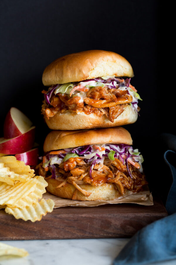 _*Crockpot BBQ Pulled Chicken*_ /It's made with tender flavorful chicken thighs, a simple spice rub, and robust store-bought sauces to save time. This chicken makes for the ultimate BBQ chicken sandwiches and it's incredibly easy!/   #BarbecueSauce #Buns #CayennePepper #ChickenThighs #ChiliPowder #GarlicPowder #Onion #Paprika #SteakSauce  Servings: 8 Ready in: 4 hours 45 minutes Prep: 15 minutes Cook: 4 hours 30 minutes  Ingredients:  3 lbs. boneless, skinless chicken thighs 1 1/2 tsp chili powder 1 1/2 tsp smoked paprika 1/2 tsp garlic powder 1/4 tsp cayenne pepper (optional) 1/2 tsp salt, then more to taste 1 tsp freshly ground black pepper 1/4 cup grated yellow onion 1 1/2 cups BBQ sauce (recommend Bullseye original), divided 2 Tbsp steak sauce (recommend A1) 8 hamburger buns  Instructions: *1.* Place chicken in 5 - 7 quart slow cooker (I use this one).  *2.* In a small mixing bowl whisk together chili powder, paprika, garlic powder, cayenne pepper, salt, and pepper.  *3.* Pour spice mixture over chicken and add grated onion. Toss well to evenly coat chicken with spices.  *4.* Evenly pour 3/4 cup BBQ sauce over the chicken.  *5.* Cover and cook on low heat 4 - 6 hours until chicken shreds easily and registers 165 degrees in center.  *6.* Transfer chicken to a cutting board, reserve liquid from the slow cooker. Skim fat from the liquid and discard the fat.  *7.* Shred chicken with two forks (I do it a little larger than I want it to end up because as you toss again in the next step it shreds up a bit on it's own).  *8.* Return chicken to slow cooker. Heat remaining 3/4 cup BBQ sauce with 2 Tbsp steak sauce in a microwave safe bowl in the microwave until warm (about 1 - 2 minutes).  *9.* Pour 3/4 cup of the reserved liquid and the BBQ sauce mixture over the chicken then toss to evenly coat. If you feel it needs a little more moisture you can add another splash of the reserved liquid (or more BBQ sauce), also season to taste with a little more salt if needed.  *10.* Serve the pulled bbq chicken in hamburger buns (I also like to add coleslaw, with a little blue cheese mixed in sometimes too).