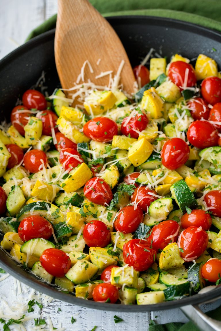_*Sauteed Garlic-Parmesan Zucchini Squash and Tomatoes*_ /This skillet sauteed zucchini, squash and tomatoes is a simple side dish that's the perfect accompaniment to your favorite summer meals. It's deliciously flavorful thanks to the garlic and parmesan flavors and it has such a fun colorful blend. A new summer staple!/   #GarlicPowder #ItalianSeasoning #Parmesan #Squash #Tomatoes #Zucchini  Servings: 5 Ready in: 18 minutes Prep: 10 minutes Cook: 8 minutes  Ingredients:  1 Tbsp olive oil 1 Tbsp butter 12 oz . zucchini (about 2 medium), diced into 1/2-inch pieces 12 oz . yellow squash (about 2 medium), diced into 1/2-inch pieces 1 1/2 cups grape tomatoes 3/4 tsp Italian seasoning 3/4 tsp garlic powder Salt and freshly ground black pepper 1/2 cup finely shredded parmesan cheese  Instructions: *1.* Heat olive oil and butter in a 12-inch non-stick skillet over medium-high heat. Add in zucchini and squash and saute 2 minutes.   *2.* Add in tomatoes then evenly sprinkle in Italian seasoning, garlic powder, and season with salt and pepper to taste (about 3/4 tsp salt and 1/4 tsp pepper).   *3.* Continue to saute, tossing occasionally, until squash is tender and tomatoes are beginning to burst, about 3 - 5 minutes longer.   *4.* Sprinkle in half the parmesan and toss then sprinkle remaining parmesan over top. Serve warm.
