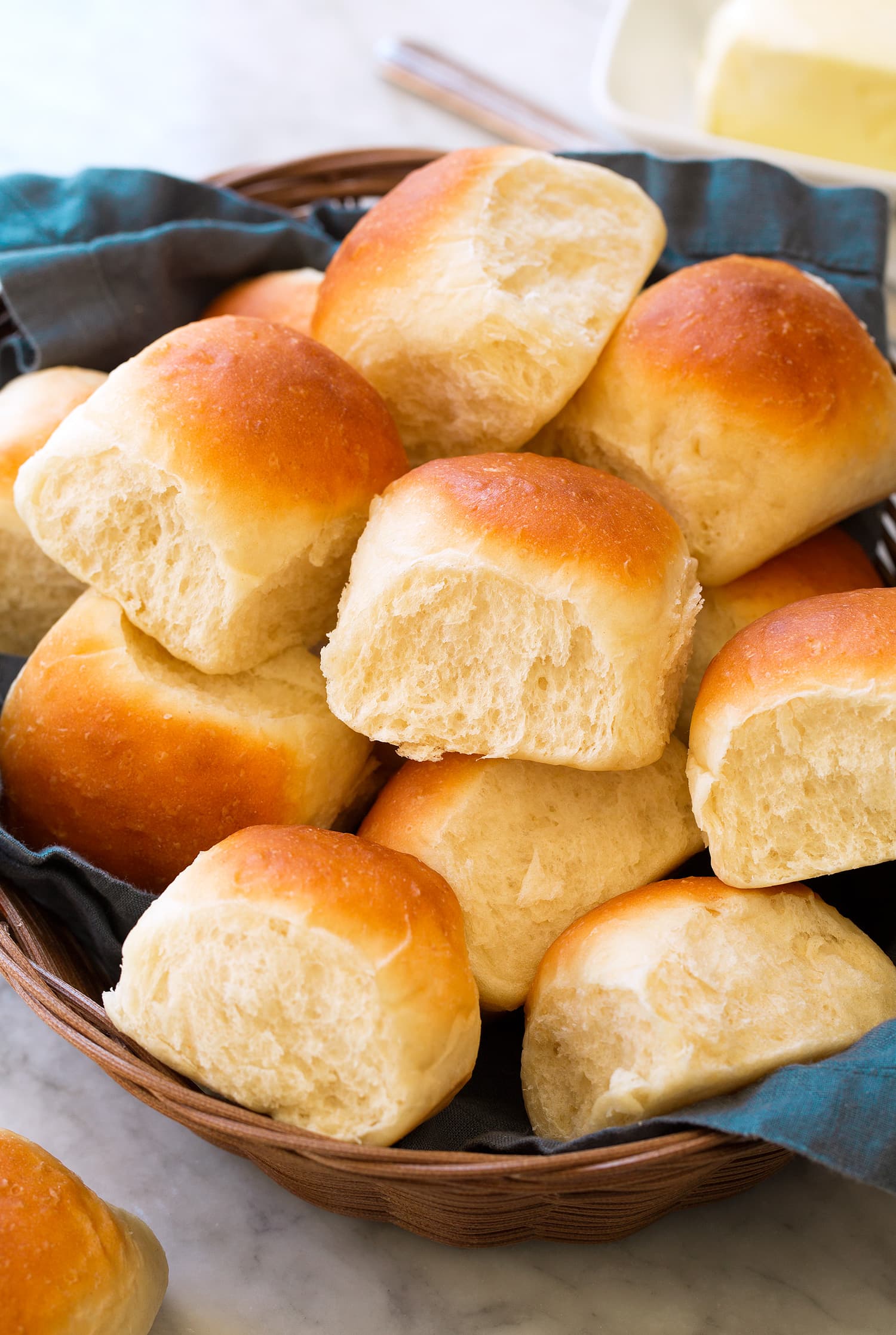 _*Easy One-Hour Dinner Rolls*_ /Fast and easy Dinner Rolls that are perfectly soft and tender, beautifully fluffy and ready from start to finish in just 1 hour!/   #Butter #Flour #Milk #Sugar #Yeast  Servings: 15 rolls Ready in: 1 hour Prep: 20 minutes Cook: 15 minutes  Ingredients:  3 1/2 cups (17.5 oz) to 4 cups all-purpose flour (scooped and leveled) 1/4 cup granulated sugar 1 Tbsp rapid rise yeast 1 1/2 tsp salt 3/4 cup cool water 3/4 cup milk 4 Tbsp unsalted butter, diced into 1 Tbsp pieces, plus more for tops 1 1/2 tsp lemon juice  Instructions: *1.* Preheat oven to 180 degrees Fahrenheit. In the bowl of an electric stand mixer whisk together 3 1/2 cups flour, the sugar, yeast and salt.  *2.* To a medium bowl add water, milk and butter and heat in microwave on HIGH power until it reaches 120 degrees on a thermometer, about 1 minute 15 seconds. Stir to partially melt butter (you just want to make sure it's softened through).  *3.* Pour milk mixture into dry mixture in bowl of electric stand mixer along with lemon juice.   *4.* Set mixer with a hook attachment then set mixer on low speed and gradually increase to medium-low, knead about 3 minutes until smooth and elastic while adding additional flour as necessary (dough should be lightly sticky but manageable).  *5.* Cover bowl tightly with plastic wrap and rest 5 minutes. Meanwhile butter a 13 by 9-inch baking dish.  *6.* Drop dough onto a lightly floured surface. Shape into an evenly level square, about 9 by 9-inches. Cut into 16 equal portions (don't have to be exact) *7.* Shape dough into 15 balls, while using excess dough from the 16th portion to add to smaller rounds as needed, and place shaped dough portions into prepared baking dish.  *8.* Dampen hands with water and brush tops of dough with the water (just so they don't dry while rising in oven). Transfer to oven, close oven and turn oven off, allow rolls to rise 20 minutes (don't open oven door).  *9.* Remove from oven and preheat oven to 375 degrees Fahrenheit (this should take about 5 minutes, so just allow rolls to rest on counter while oven preheats).  *10.* Bake in preheated oven 14 - 16 minutes until tops are golden brown. Remove from oven and run the top of a stick of butter along tops of rolls just to coat. Serve warm. Store in an airtight container (I recommend rewarming cool rolls in microwave for best results.