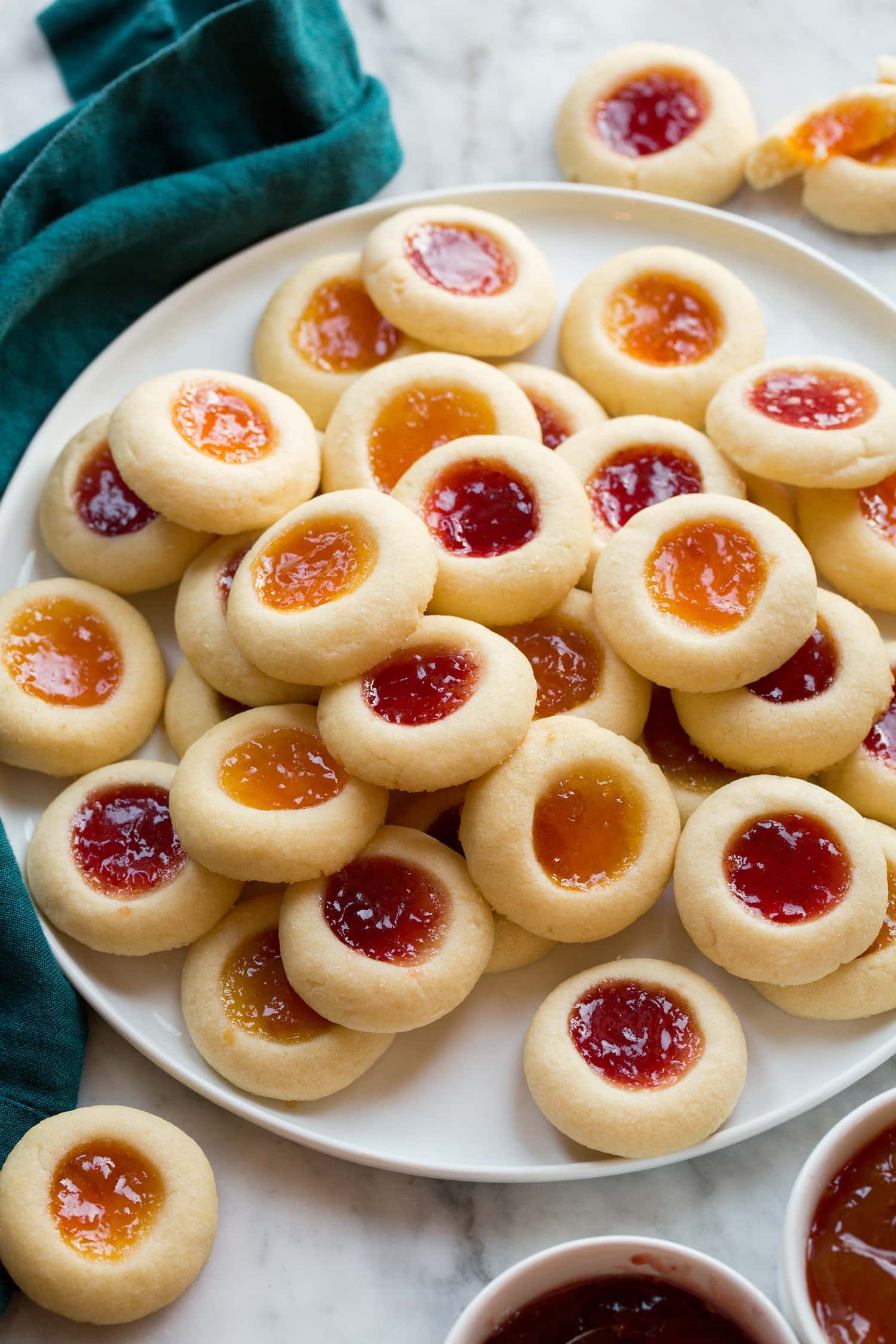 _*Thumbprint Cookies*_ /Thumbprint Cookies are tender, buttery cookies that are thumb pressed to create a well that’s filled with sweet fruity jam before baking. These colorful, glistening cookies are a traditional holiday treat that people of all ages love!/ #Butter #EggYolks #Flour #Jam #Sugar Servings: 32 Ready in: 1: hour hour 16 minutes Prep: 30 minutes Cook: 13 minutes Ingredients: 2/3 cup (135g) granulated sugar 1/4 tsp salt 1 cup (226g) unsalted butter, at room temperature 2 large egg yolks* 1 tsp vanilla extract 2 cups (283g) all-purpose flour (scoop and level to measure) 1/2 cup fruit preserves or jam, such as Bonne Maman Instructions: *1.* Pour sugar and salt into bowl of stand mixer and whisk. *2.* Add butter to sugar and blend mixture using the paddle attachment until well creamed together. Scrape down bowl. *3.* Mix in egg yolks and vanilla extract, scrape down bowl. *4.* Add flour and mix until combined. *5.* Scoop dough out and shape into 1-inch balls (just slightly over 1 Tbsp each, or 20g). Place on a flat dish lined with parchment paper and make an indent in each cookie using thumb or a wine cork (just don't push all the way through the dough, but make large enough to fit 1/2 tsp of jam). *6.* Freeze the shaped cookie doughs for 20 minutes. Meanwhile preheat oven to 350 degrees. *7.* Remove half of the shaped thumbprints and place on a parchment paper lined baking sheet spacing 2-inches apart. Fill with 1/2 tsp jam in each indent. *8.* Bake in preheated oven 13 to 15 minutes until nearly set. Let cool several minutes then transfer to a wire rack to cool completely. *9.* Repeat with remaining cookie dough. Store cookies in an airtight container at room temperature. Notes: Coat cookies in nuts or coconut: Save the egg whites. Whisk the egg whites until frothy then brush egg white over cookie dough balls. Then roll the cookie dough balls in finely chopped nuts or shredded sweetened coconut before making indentation in center. Add other fillings: Cookies can also be baked unfilled then after baking gently re-press the indentation back down with a teaspoon, fill with dulce de leche, melted caramel, lemon curd, frosting, or chocolate ganache.