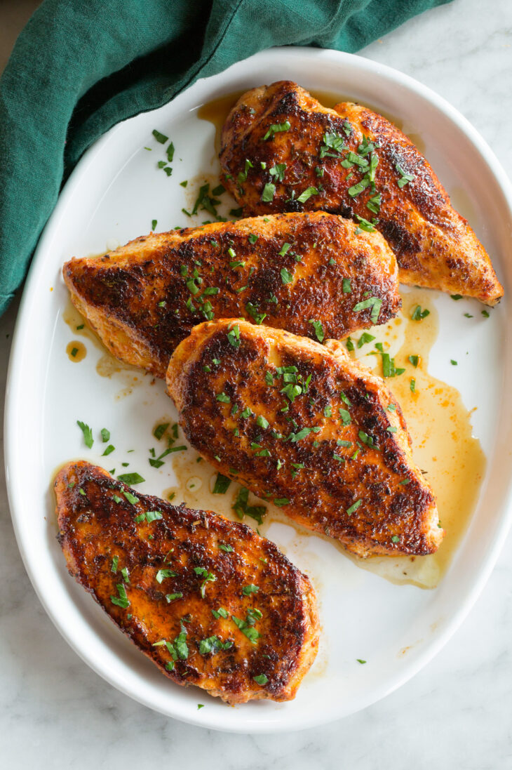 _*Blackened Chicken*_ /Blackened Chicken is a quick chicken dish made with lean chicken breasts generously coated with a spicy cajun style seasoning, and it’s pan seared in a hot cast iron pan for a light blackened char. And for a hint of richness we finish them with butter!/   #Healthy #MainDish #Poultry #Butter #CayennePepper #ChickenBreasts #GarlicPowder #OnionPowder #Oregano #Paprika #SmokedPaprika #Thyme  Prep: 15 minutes. Cook: 10 minutes. Ready in: 25 minutes.  Ingredients: 1: 4 (6 oz each) boneless skinless chicken breasts, pounded to an even 1/2-inch thickness. 2: 1 tsp smoked paprika. 3: 3/4 tsp paprika. 4: 1/2 tsp garlic powder. 5: 1/2 tsp onion powder. 6: 1/2 tsp cayenne pepper, or to taste (this is spicy). 7: 1/2 tsp dried oregano. 8: 1/2 tsp dried thyme. 9: 1/2 tsp salt, or to taste. 10: 1/2 tsp ground black pepper. 11: 1 Tbsp light olive oil or vegetable oil. 12: 2 Tbsp butter, melted. 13: 2 tsp chopped fresh parsley, for garnished (optional).  Instructions: 1: In a mixing bowl whisk together smoked paprika, sweet paprika, garlic powder, onion powder, cayenne pepper, oregano, thyme, salt and black pepper. 2: Sprinkle both sides of each piece of chicken evenly with spice mixture. 3: Preheat a cast iron skillet over medium-high heat. Add oil and coat bottom of skillet. 4: Place chicken in skillet and cook until slightly blackened on bottom, about 4 minutes. Turn and continue to cook until chicken has cooked through (165 degrees in center), about 4 minutes longer. If needed at any time during cooking you can reduce burner temperature to medium if chicken is becoming too dark before cooking through. 5: Plate chicken and drizzle with butter. If desired you can garnish with a little chopped fresh parsley. Notes: *Don't use extra virgin olive oil or it will smoke, either light olive oil or vegetable oil. This chicken is delicious with coconut rice, corn on the cob, and mango avocado salsa.    