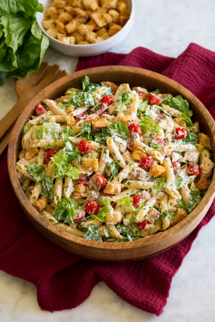 _*Chicken Caesar Pasta Salad*_ /Chicken Caesar Pasta Salad is a delicious blend of two incredible side dishes, pasta salad meets a traditional green salad. It’s brimming with vibrant flavor, has a satisfying blend of textures, and it’s sure to be a hit at your next summer get together!/    #AppetizersSalads #MainDish #PastaItalian #Poultry #Anchovies #Chicken #DijonMustard #Garlic #GreekYogurt #Lemons #Lettuce #OliveOil #Parmesan #Pasta #Tomatoes #Worcestershire  Prep: 20 minutes. Cook: 15 minutes. Ready in: 35 minutes.  Ingredients: 1: 5 anchovy fillets, canned in oil (drained). 2: 3/4 cup mayonnaise. 3: 3 Tbsp fresh lemon juice. 4: 1/4 cup finely grated parmesan cheese. 5: 1 1/2 tsp dijon mustard. 6: 2 tsp Worcestershire sauce. 7: 1 1/2 tsp minced garlic. 8: Salt and black pepper, to taste. 9: 10 oz. dry penne pasta. 10: 4 cups (slighlty packed) chopped romaine lettuce (preferably romaine hearts or the center portion). 11: 1 lb boneless skinless chicken breasts, grilled, cooled, then chopped. 12: 1 pint grape tomatoes, halved. 13: 3/4 cup finely shredded parmesan cheese. 14: 2 Tbsp chopped fresh parsley. 15: 2 cup croutons, homemade or store-bought. 16: 1/2 cup reserved pasta water, to thin as needed.  Instructions: 1: Cook pasta in salted water according to directions on package. Reserve 1/2 cup pasta cooking water and set aside to cool. Drain pasta then transfer to an 18 by 13-inch rimmed baking sheet that's sprayed with non-stick cooking spray or lined with parchment paper and let cool completely. 2: Mince anchovies and place in a medium mixing bowl, mash to a paste with the back of a spoon. Add in mayonnaise, lemon juice, parmesan, dijon mustard, Worcestershire sauce, garlic, and salt and pepper to taste. Whisk to blend. Chill in fridge until ready to use. 3: Add cooled pasta, lettuce, chicken, tomatoes, and parsley to a large salad bowl. Pour dressing over top and toss to evenly coat, thin mixture with pasta water as needed (it will thicken as it sits). 4: Add croutons and parmesan and toss a few times incorporate. Notes: Serve within a few hours of preparing as the lettuce will start to wilt. Keep chilled. You can make the pasta salad in advance just wait to add the croutons and the lettuce. Also set aside 1/4 cup dressing (in the fridge) to toss with the lettuce before adding to the pasta salad. And you can thin the pasta salad with a little water the next day before adding the lettuce and croutons.  
