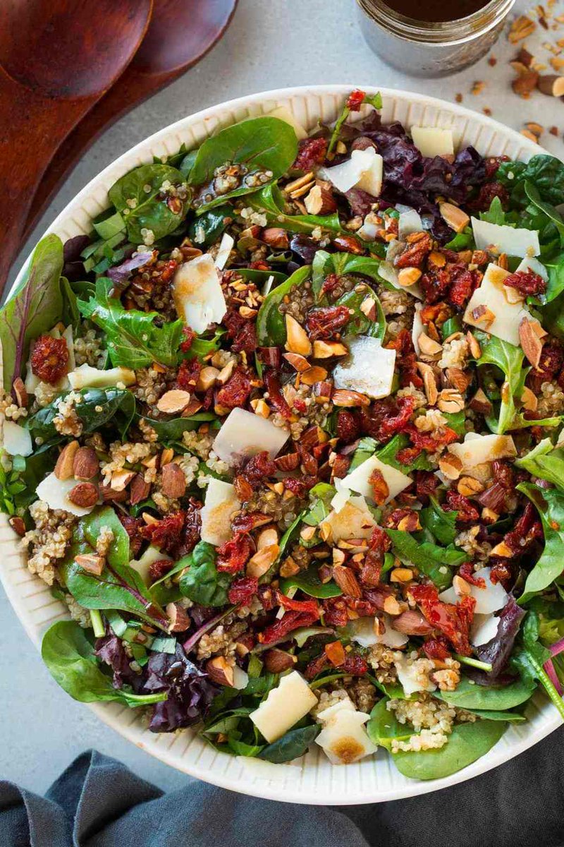 _*Sun Dried Tomato Quinoa Salad with Balsamic Vinaigrette*_ /A salad layered with tender spring lettuces, hearty quinoa, crunchy toasted almonds, bold parmesan, chewy bright sun dried tomatoes and a final finish of a tangy, rich balsamic vinaigrette. So much goodness in one super satisfying salad!/   #Almonds #BalsamicVinegar #Honey #Lettuce #OliveOil #Parmesan #Quinoa #SunDriedTomatoes  Servings: 4 Ready in: 20 minutes Prep: 20 minutes Cook: 5 minutes  Ingredients:  5 oz. baby spring lettuce blend 1/4 cup basil ribbons 1 1/4 cups cooked and chilled quinoa 1/3 cup shaved parmesan, slightly crumbled 1/2 cup almonds, chopped and toasted 1/4 cup well drained julienned sun dried tomatoes packed in olive oil, chopped (reserve oil) Balsamic Vinaigrette 1/4 cup oil from jar of sun dried tomatoes 2 Tbsp balsamic vinegar 1 tsp minced garlic 1 tsp honey 1 tsp dijon mustard Salt and freshly ground black pepper, to taste  Instructions: *1.* For the dressing combined all of the dressing ingredients in a jar, cover with lid and shake to blend.  *2.* In a salad bowl layer together spring lettuce blend, basil, quinoa, parmesan, almonds and sun dried tomatoes.   *3.* Shake dressing again and pour over salad.  *4.* Toss to coat and serve immediately.  *5.* Recipe source: Cooking Classy