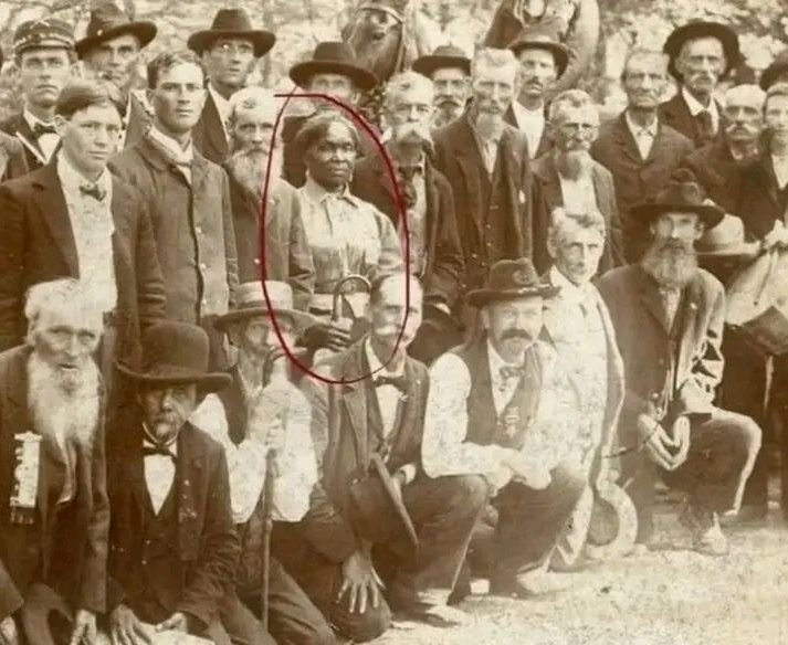 The woman circled in red is Lucy Higgs Nichols, a remarkable figure whose life story speaks to resilience and dedication. Born into slavery in Tennessee, she escaped during the Civil War and found refuge with the 23rd Indiana Infantry Regiment nearby. She stayed with them, serving as a nurse throughout the conflict, caring for soldiers amid the hardships of war.

After the war ended, Lucy moved north with the regiment, settling in Indiana and working alongside veterans of the 23rd. When Congress passed the Army Nurses Pension Act of 1892, allowing Civil War nurses to claim pensions, Lucy applied. However, the War Department had no record of her service and initially denied her pension.

In an extraordinary show of support, fifty-five surviving veterans of the 23rd petitioned Congress on her behalf, insisting she deserved this recognition. Their efforts succeeded, and Lucy was granted her pension. The photograph captures Nichols alongside her fellow veterans at a reunion in 1898, a testament to the bond they shared.

Lucy Higgs Nichols passed away in 1915 and rests in a cemetery in New Albany, Indiana, her legacy a powerful reminder of courage, loyalty, and the fight for justice. See less  https://www.facebook.com/photo/?fbid=122198580116056249&set=gwww.1706920970188572&idorvanity=1438524067028265