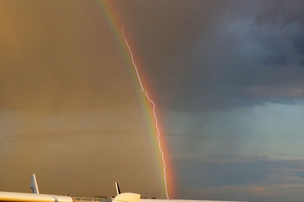 Lightning Strikes A Plane As It Flies Through A Rainbow #PerfectlyTimedPhotos 