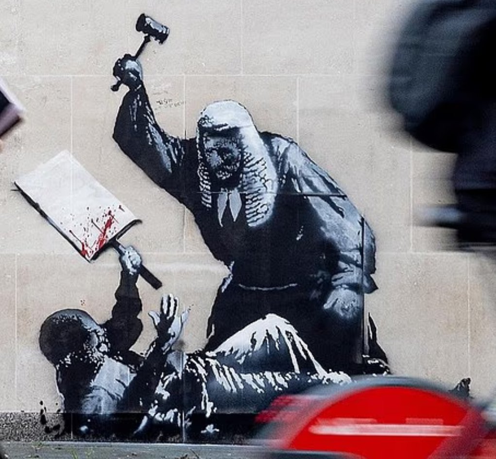 Elusive street artist Banksy unveiled a provocative mural on September 8, 2025, at London's Royal Courts of Justice, depicting a judge violently attacking a protester with a gavel. The artwork critiques the UK's judicial system amid crackdowns on protests, including over 850 arrests of pro-Palestine activists. Authorities swiftly covered it, fueling accusations of censorship and igniting widespread online debate about free speech and institutional hypocrisy.